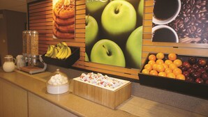 A breakfast buffet with a variety of fruits and a coffee station. - La Quinta Inn & Suites by Wyndham Boston Somerville (Somerville)