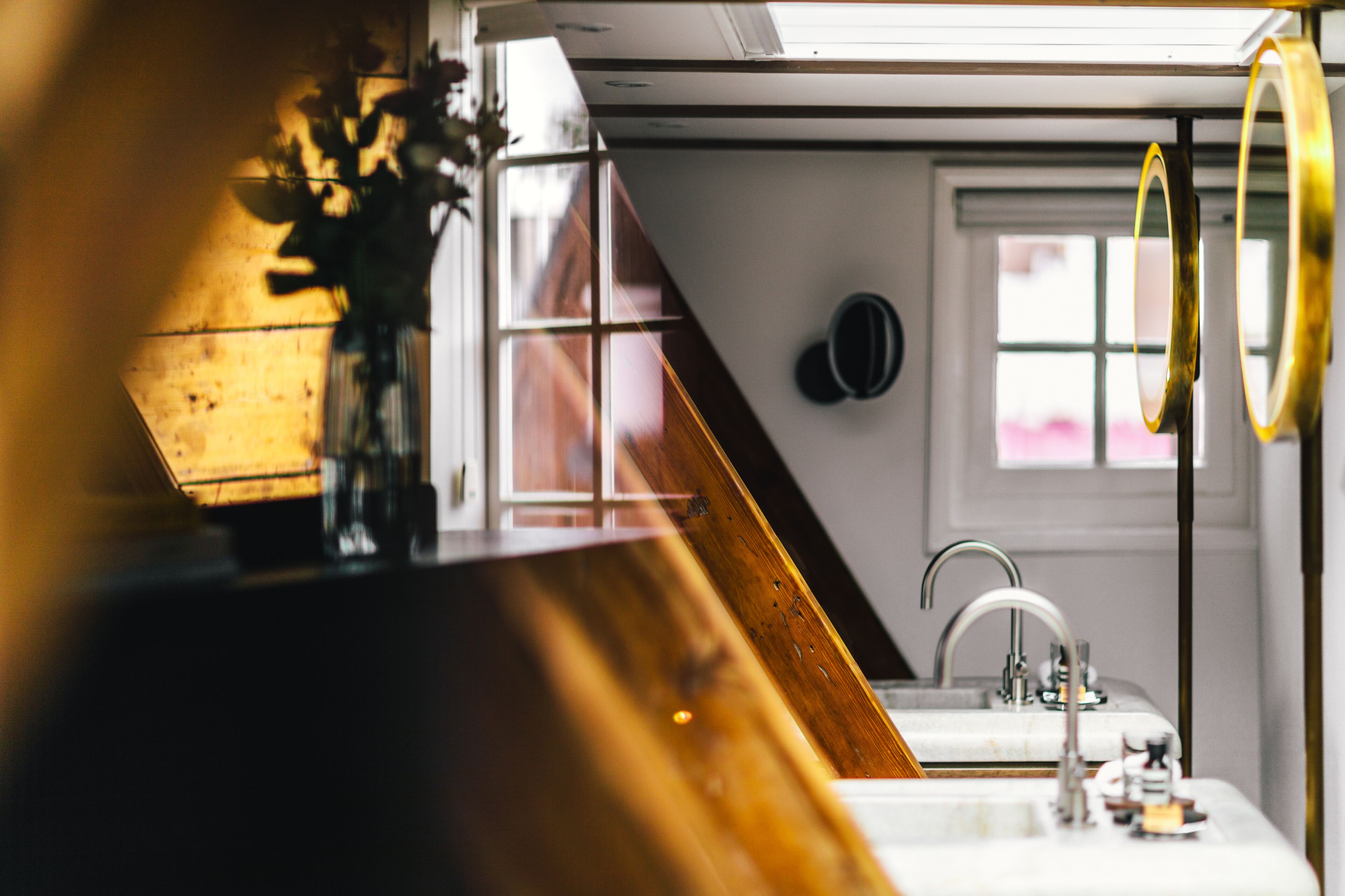 A kitchen with a wooden countertop, a sink, and a window with blinds.