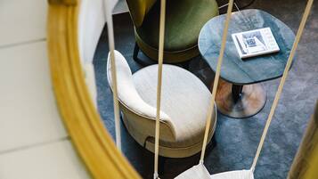 A modern interior with a round, cushioned seating area, a small table, and a book on the table.