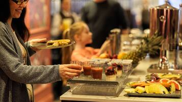 A buffet setup with various food items and beverages.