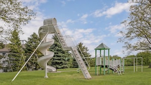 A playground with a spiral slide and a small green-roofed shelter. - Best Western Port Huron Blue Water Bridge (Port Huron)