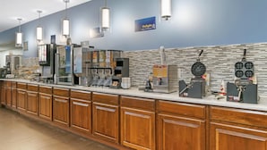 A self-service breakfast area with various food options, a coffee machine, and a sign for 'Delight Yogurt & Pastries'. - Best Western Port Huron Blue Water Bridge (Port Huron)