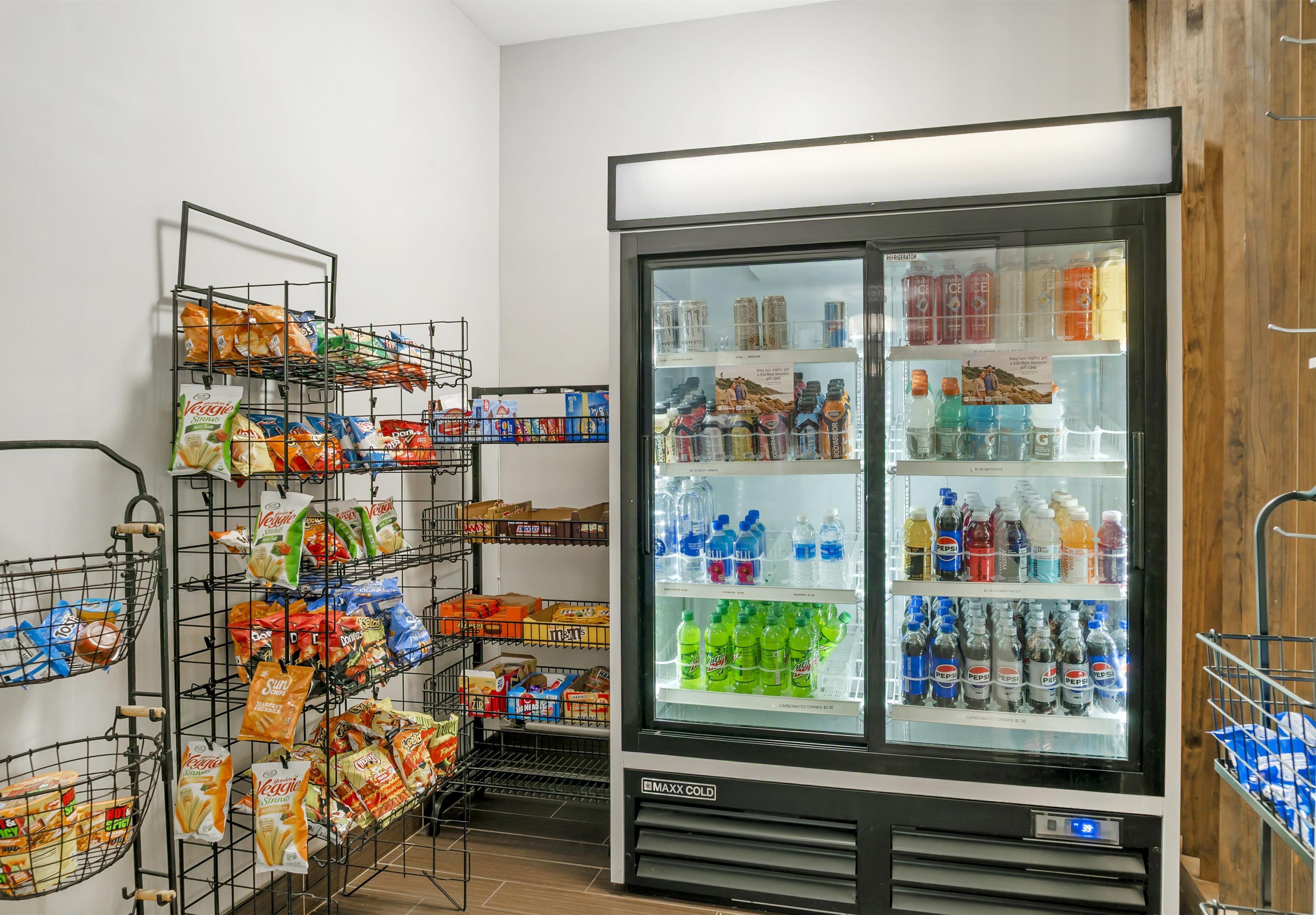 A refrigerated display case with various beverages and snacks.