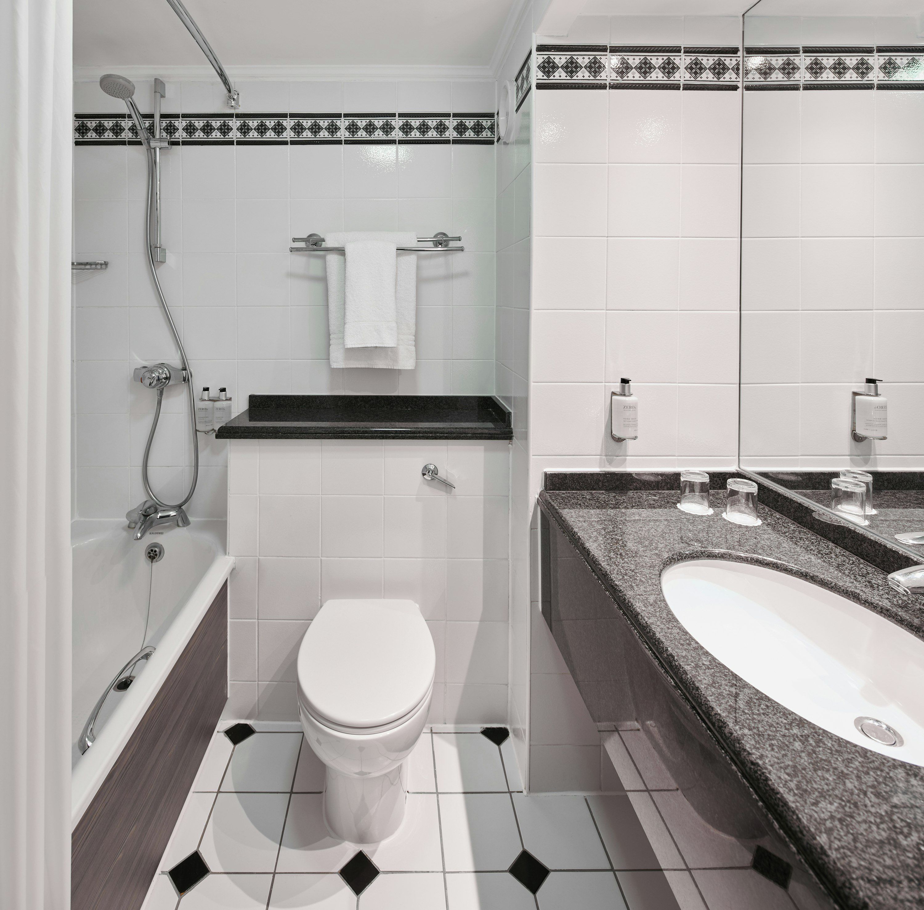A bathroom with a shower, toilet, and sink.