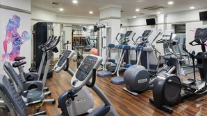 A gym with various cardio machines, including treadmills and elliptical trainers, arranged in rows. - Leonardo Hotel Middlesbrough (Middlesbrough)