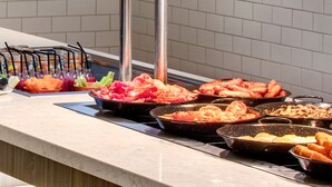 A buffet with various food items including meats, vegetables, and a fruit bowl. - Leonardo Hotel Middlesbrough (Middlesbrough)