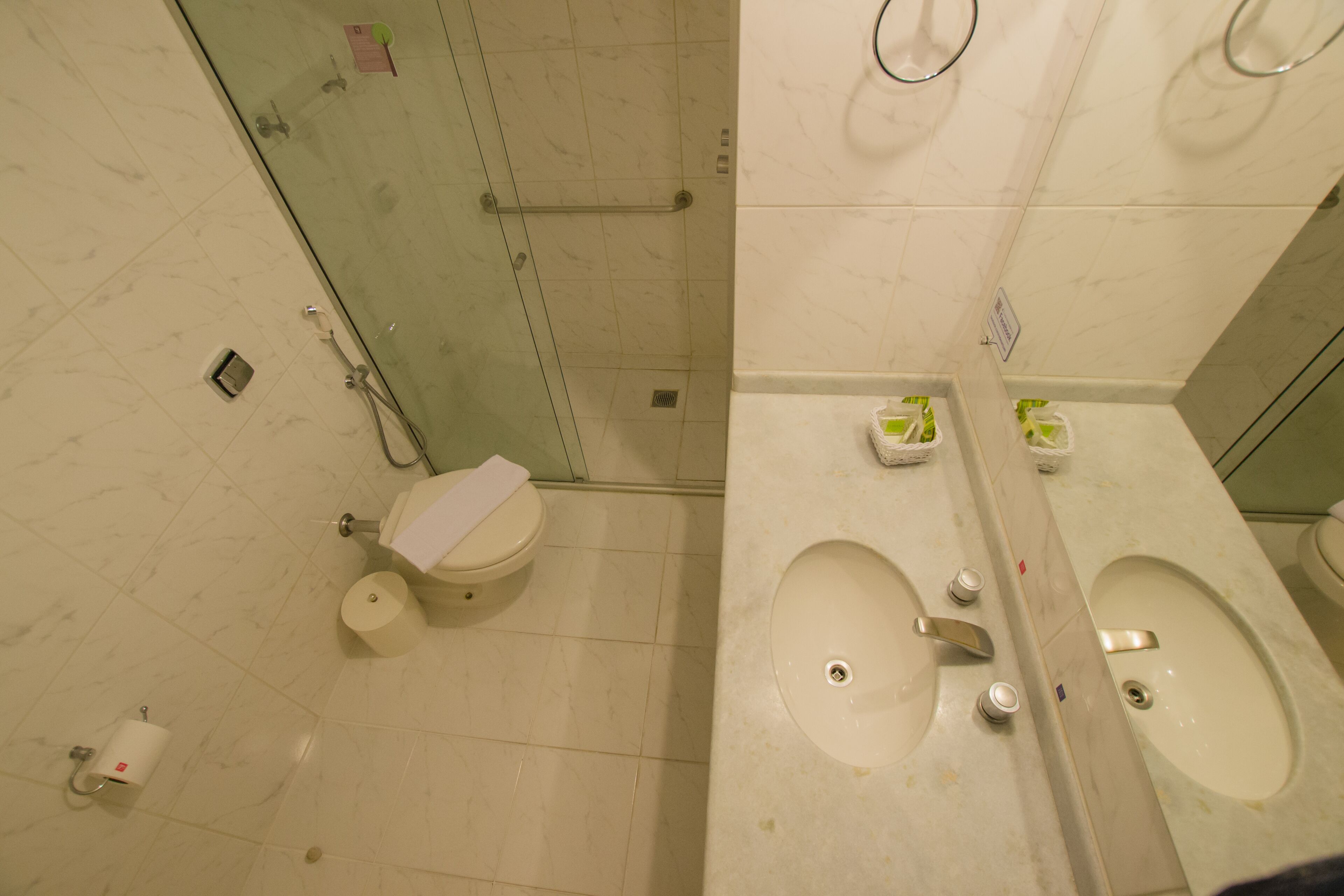 A bathroom with a toilet, a sink, and a shower.