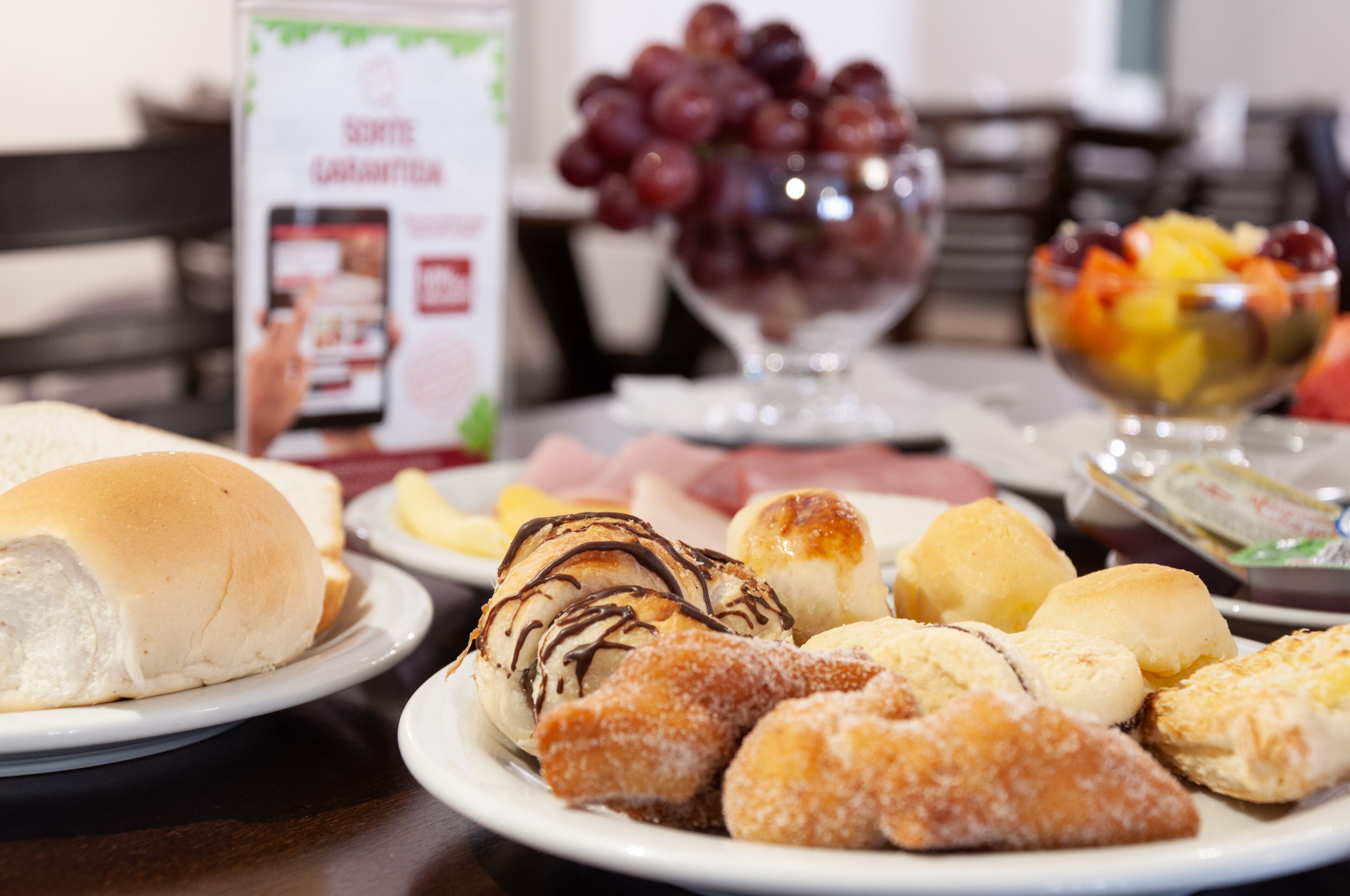 A table with various pastries and fruits.