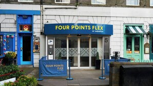 A building with a blue sign reading 'FOUR POINTS FLEX BY SHERATON' and a number '5' on the door. - Four Points Flex by Sheraton Edinburgh (Edinburgh)