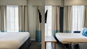A hotel room with two beds, a small table, and a chair. - Four Points Flex by Sheraton Edinburgh (Edinburgh)