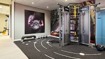 Stay fit and active with our fully equipped gym featuring a pull-up bar, squat rack, kettlebells, step platform, and yoga mat.