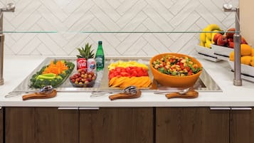 A buffet setup with various food items and beverages.