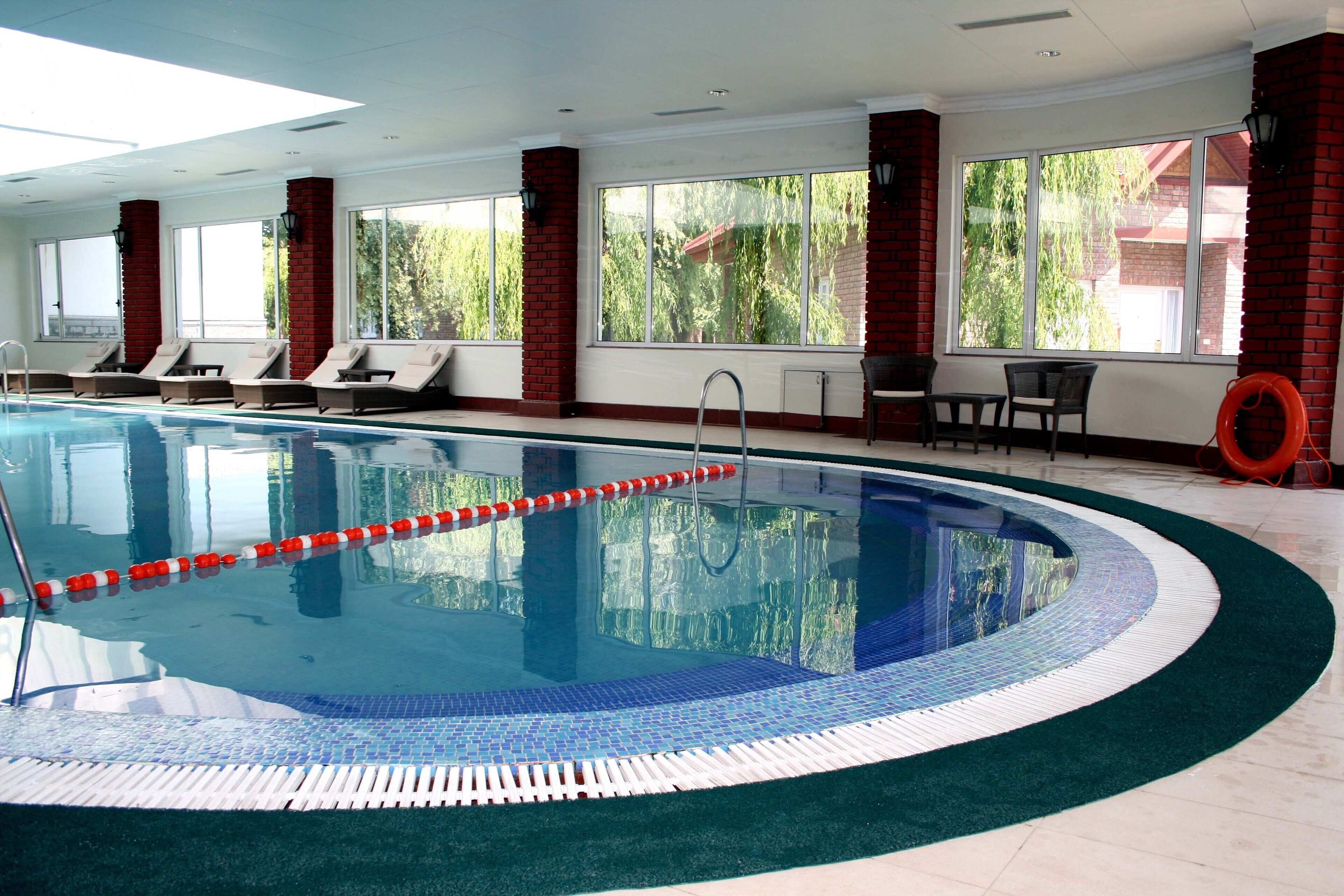 Indoor pool, open 7:00 AM to 7:00 PM, pool umbrellas