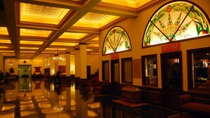 A spacious lobby with a polished floor, elegant seating arrangements, and a large stained glass window. - The Lalit Grand Palace Srinagar (Srinagar)