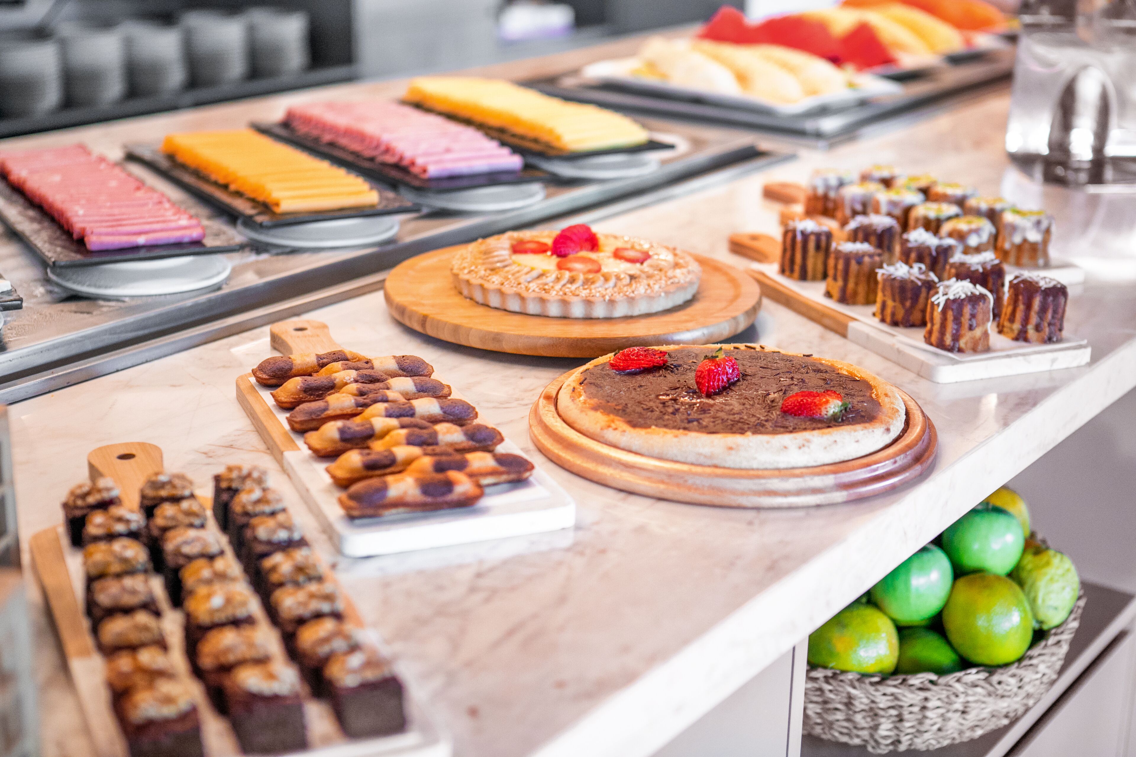 A variety of desserts and pastries on display, including cakes, cookies, and fruit tarts.