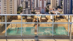 Vista a la piscina con un paisaje urbano de fondo.