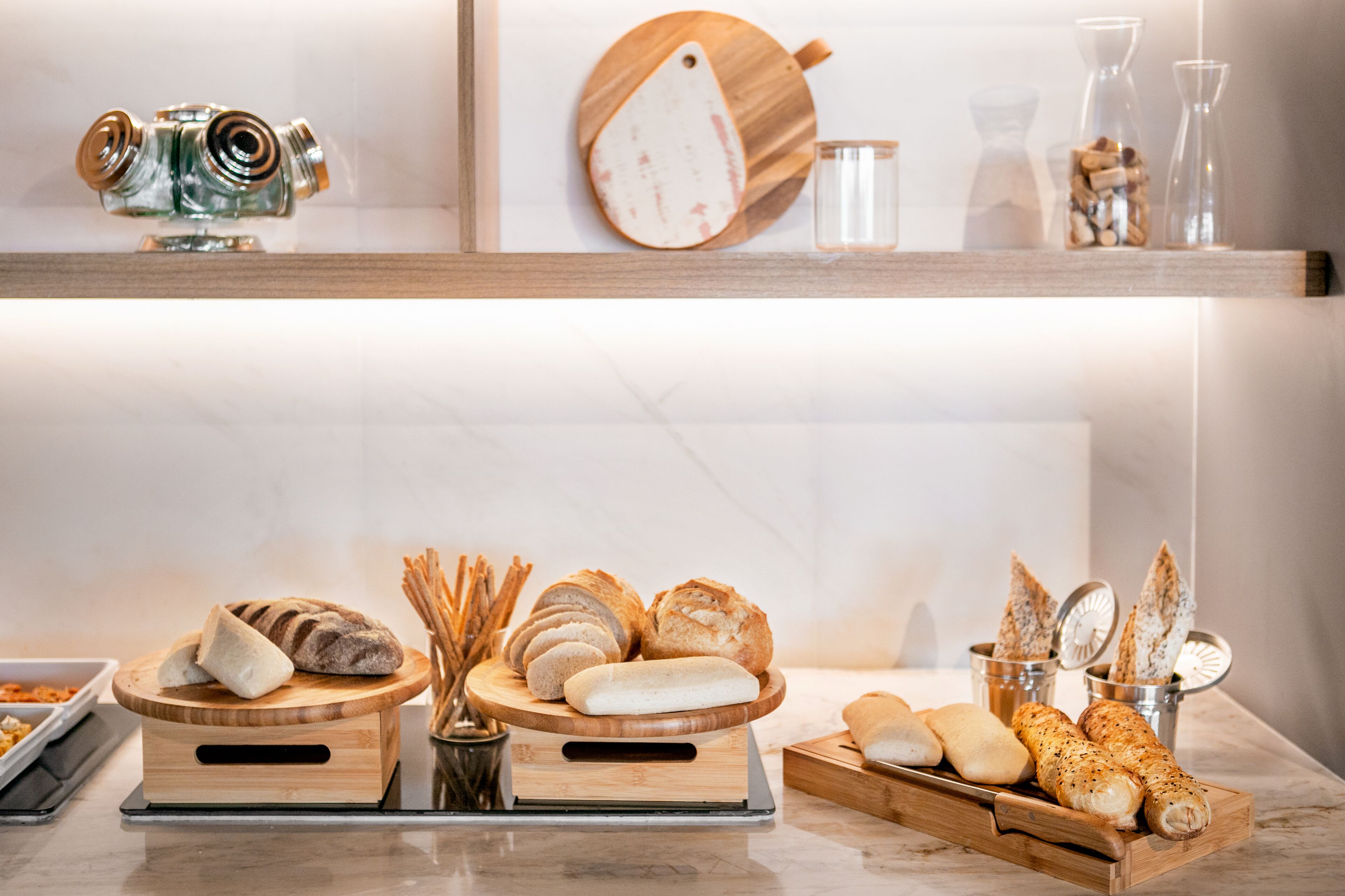 A bakery display with various breads and pastries.