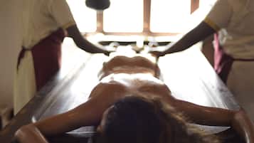 Guests can receive rejuvenating treatments in a serene room with a central treatment table and expansive views.