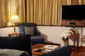 Sea Facing Deluxe Suite | Living area | 32-inch LED TV with satellite channels, TV