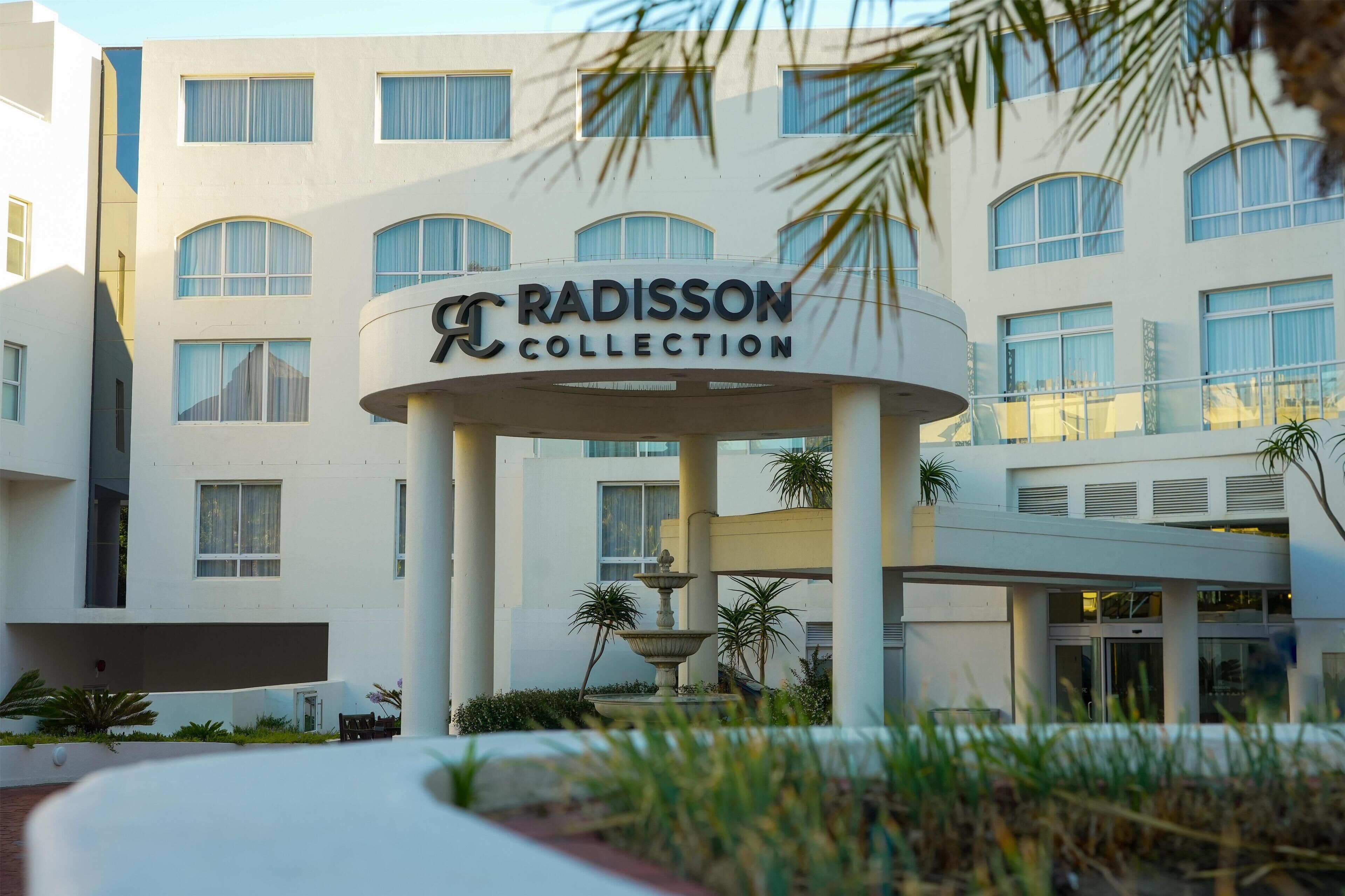 A hotel entrance with a sign reading "Radisson Collection."