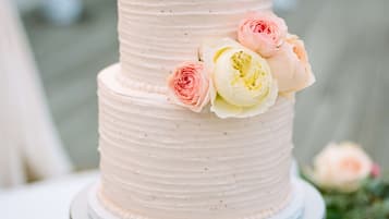 A multi-tiered cake with floral decorations on a decorative stand.