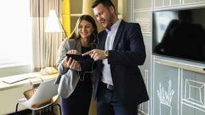 Two people in a modern office setting with a desk, chair, lamp, and a chalkboard with drawings. - ibis Zurich Messe-Airport (Zürich)
