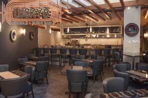 A restaurant interior with tables and chairs, a kitchen area, and a sign reading "LUCKY8 Noodle + Sushi Bar". - Mount Airy Casino Resort - Adults Only 21+ (Mount Pocono)