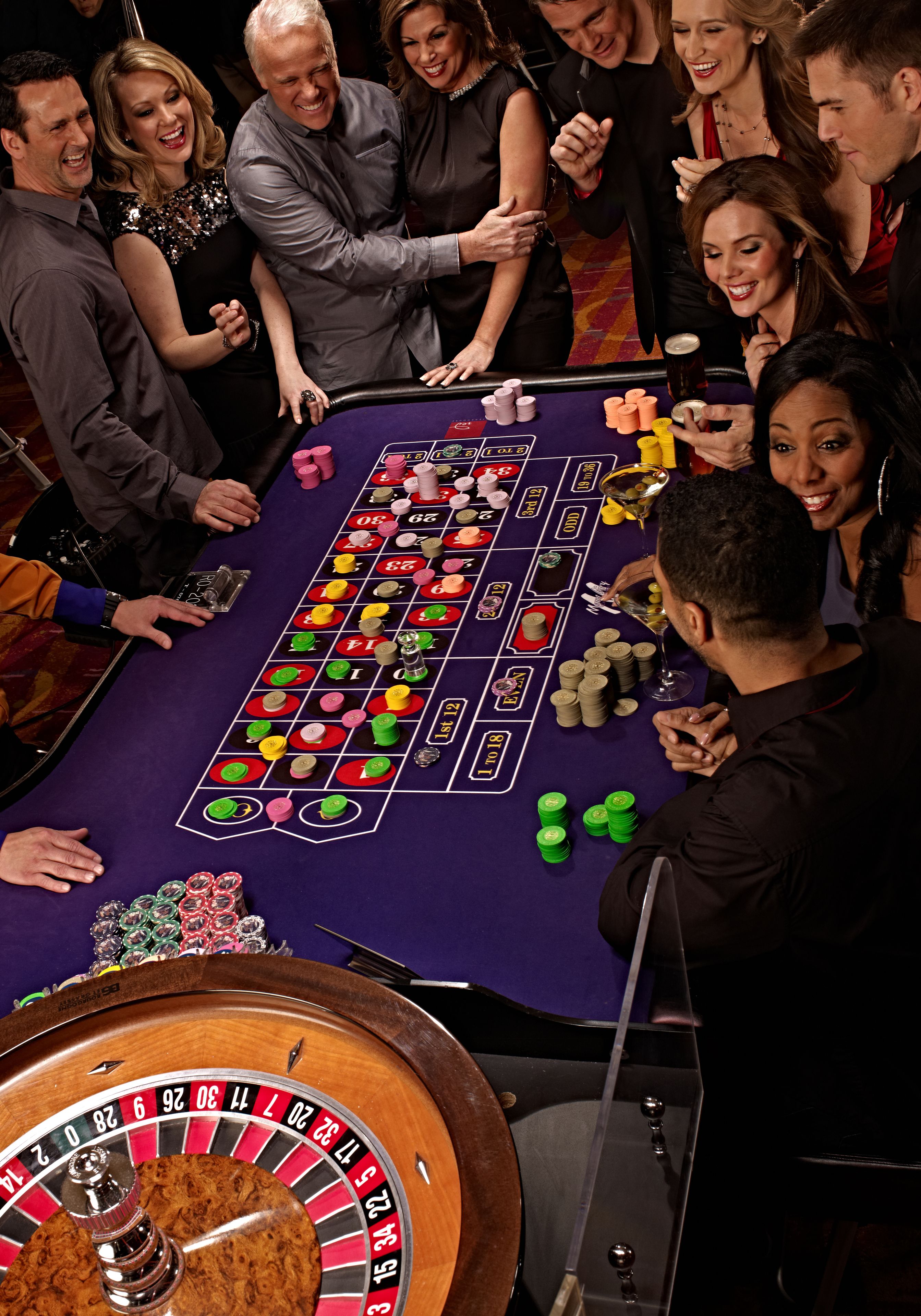 A roulette table with a wheel and chips.