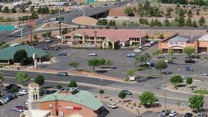 A commercial area with a parking lot, a building with a green roof, and a 'Big 5' store. - America's Best Inn & Suites St. George (St. George)