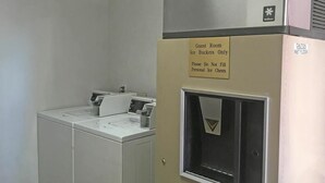 A self-service ice machine with a sign indicating it's for guest room ice buckets only and not for personal ice chests. - America's Best Inn & Suites St. George (St. George)