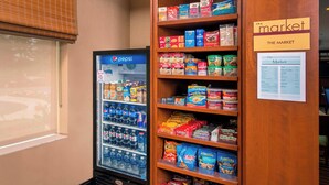 A snack and beverage vending area with a Pepsi refrigerator and a variety of snacks including chips and cereals. - Fairfield Inn & Suites Dulles Airport Chantilly (Chantilly)