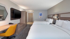 A hotel room with two beds, a desk with a chair, a television, and a door leading to another room. - Holiday Inn Express & Suites Wauseon by IHG (Wauseon)