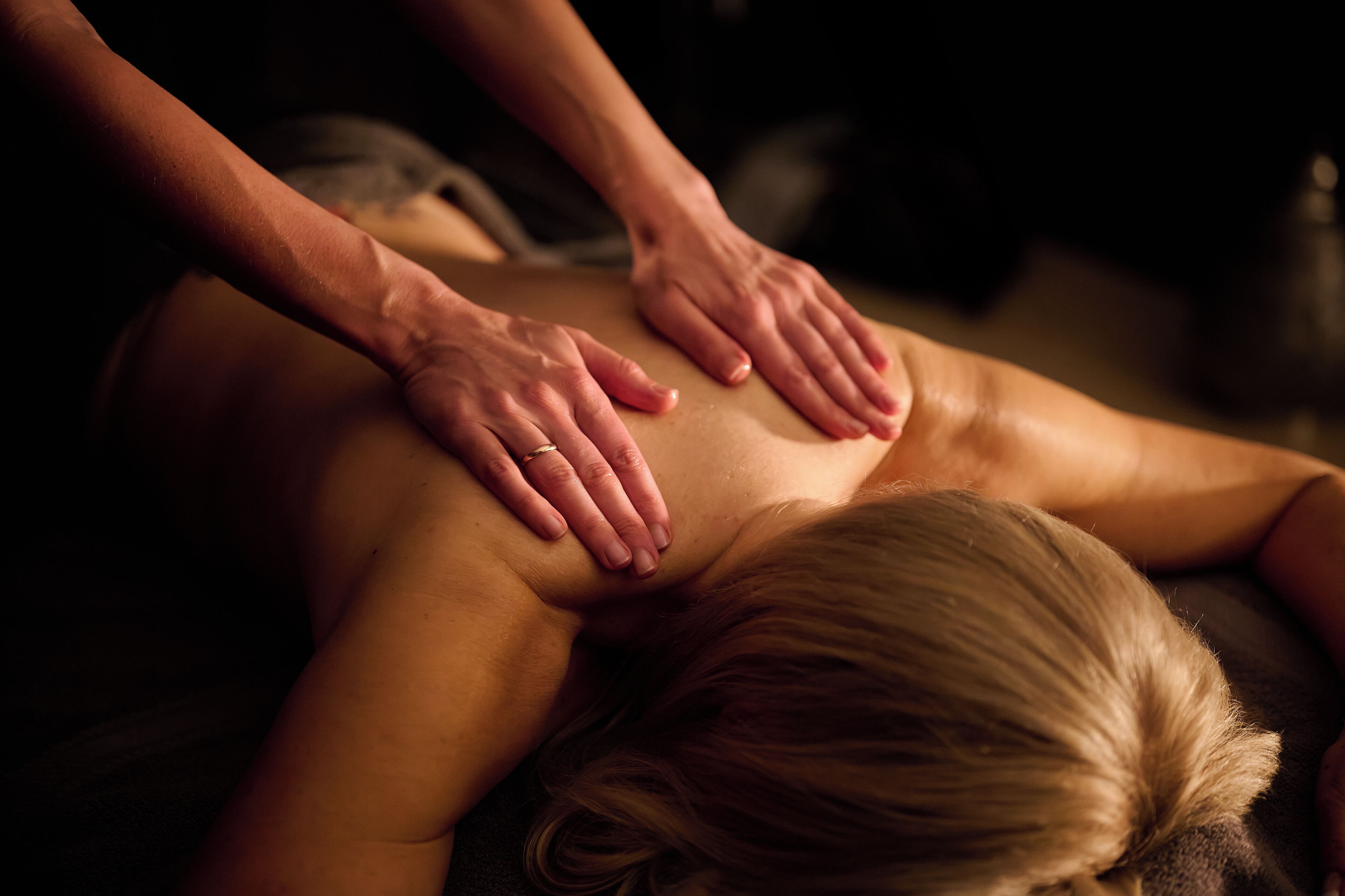 A person receiving a back massage.