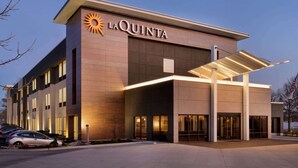 A modern hotel with a prominent 'La Quinta' sign, large windows, and a covered entrance area. - La Quinta Inn & Suites by Wyndham St Louis Route 66 (St. Louis)