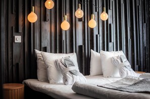 A bed with white bedding, a wooden wall, and hanging light fixtures. - Best Western Gustaf Fröding Hotel & Konferens (Karlstad)