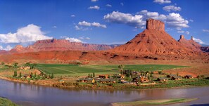 A river with a town and mountains in the background.