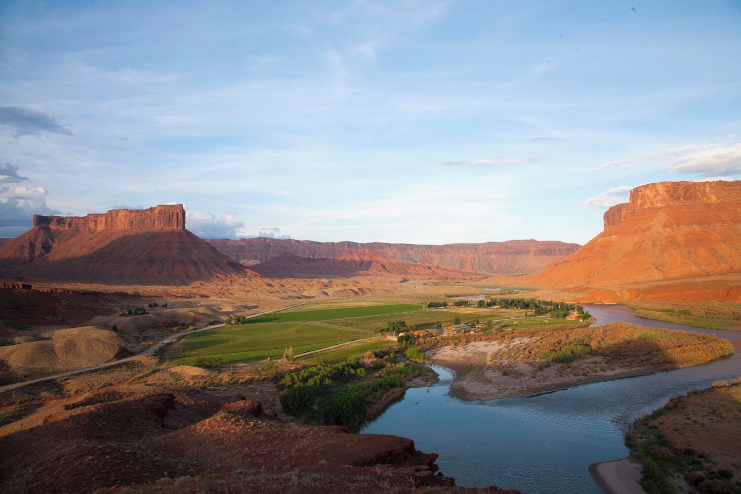 A river flowing through a valley with mountains in the background.