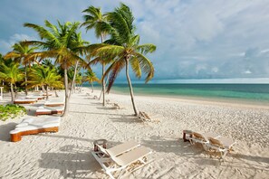 Private beach, white sand, sun loungers, beach umbrellas