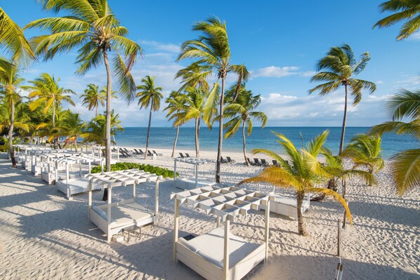 Private beach, white sand, sun loungers, beach umbrellas
