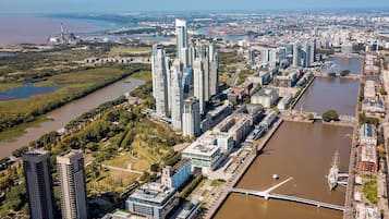 A high-rise building complex with modern architecture, a river, and a bridge.