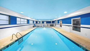 A swimming pool with clear lane markings, a diving board, and a lifeguard chair. - Hampton Inn Lincoln - South/Heritage Park (Lincoln)