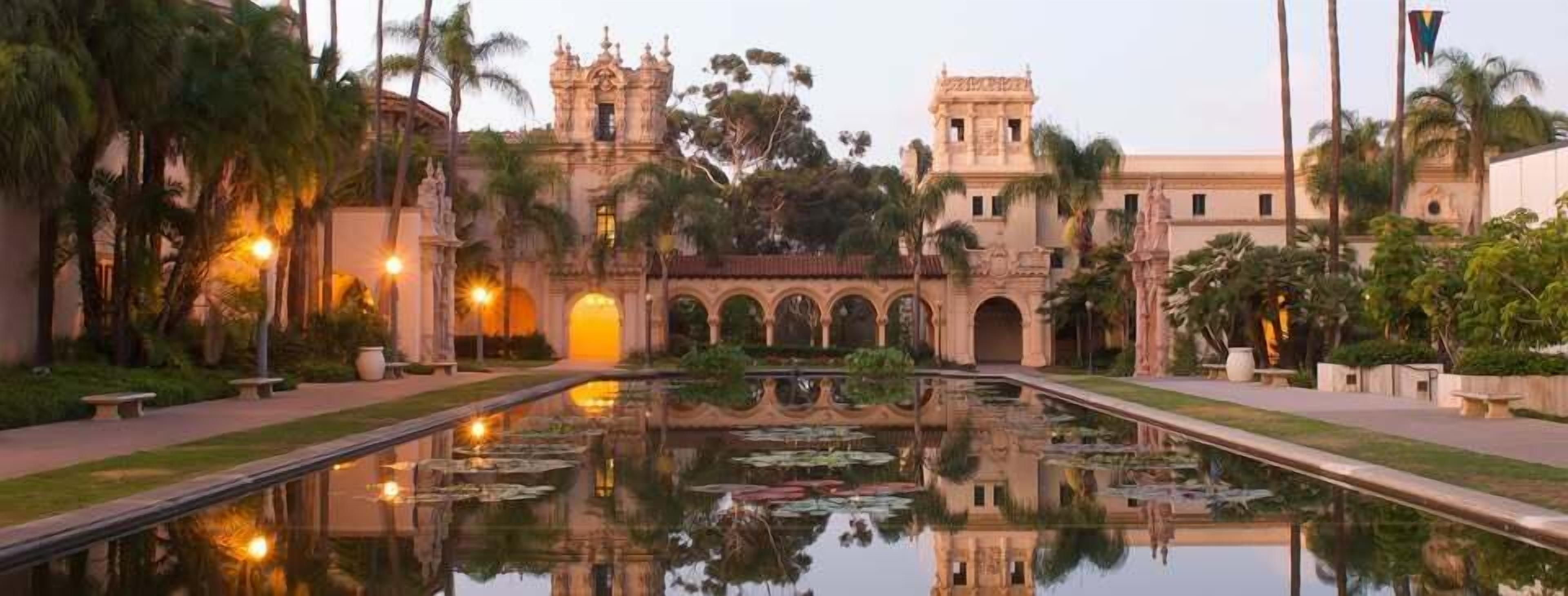 A historic building with a central courtyard and a reflective water feature. - Old Town Western Inn & Suites (San Diego)