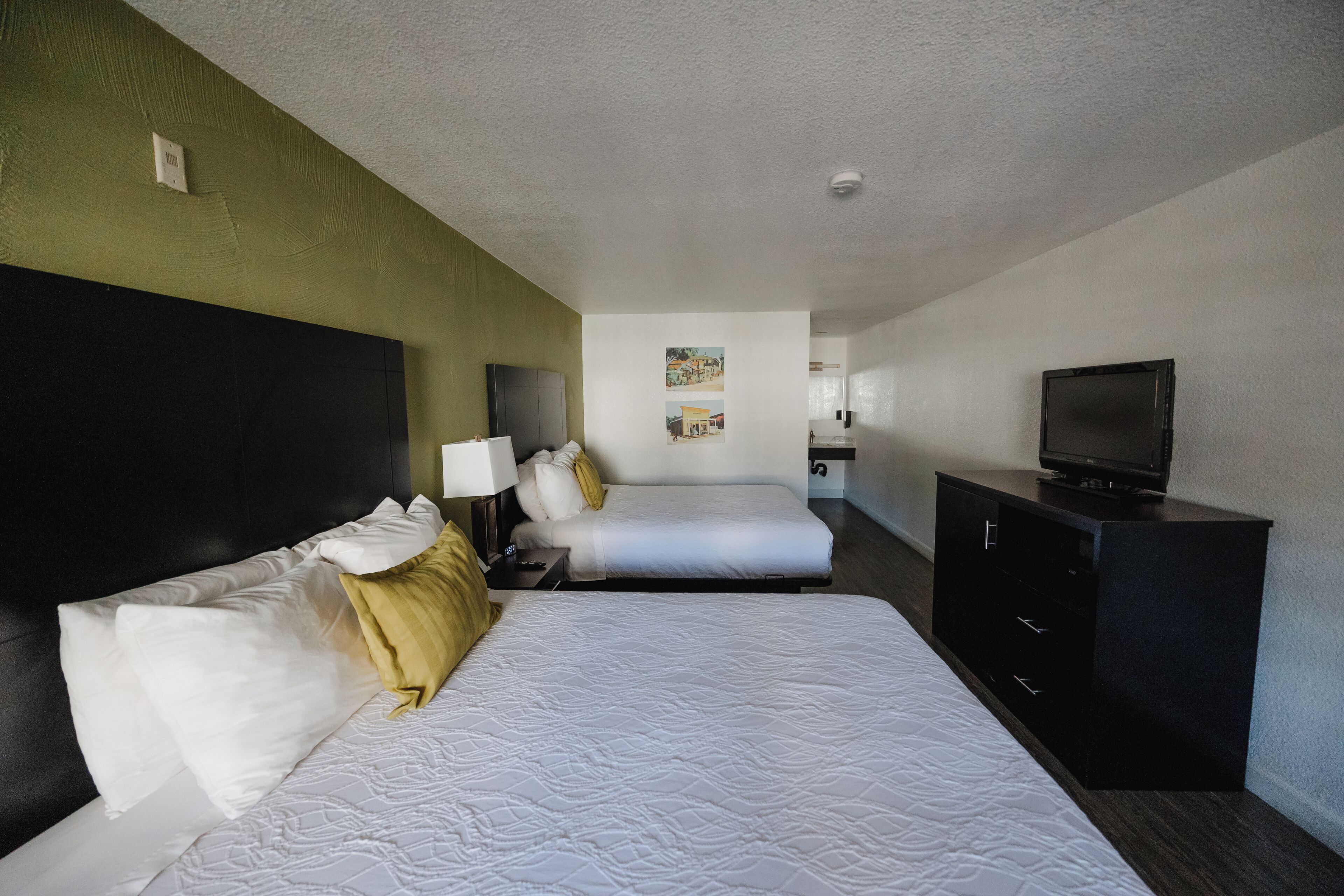 deluxe room, 2 queen beds, non smoking, refrigerator & microwave | in-room safe, iron/ironing board, free wifi, bed sheets