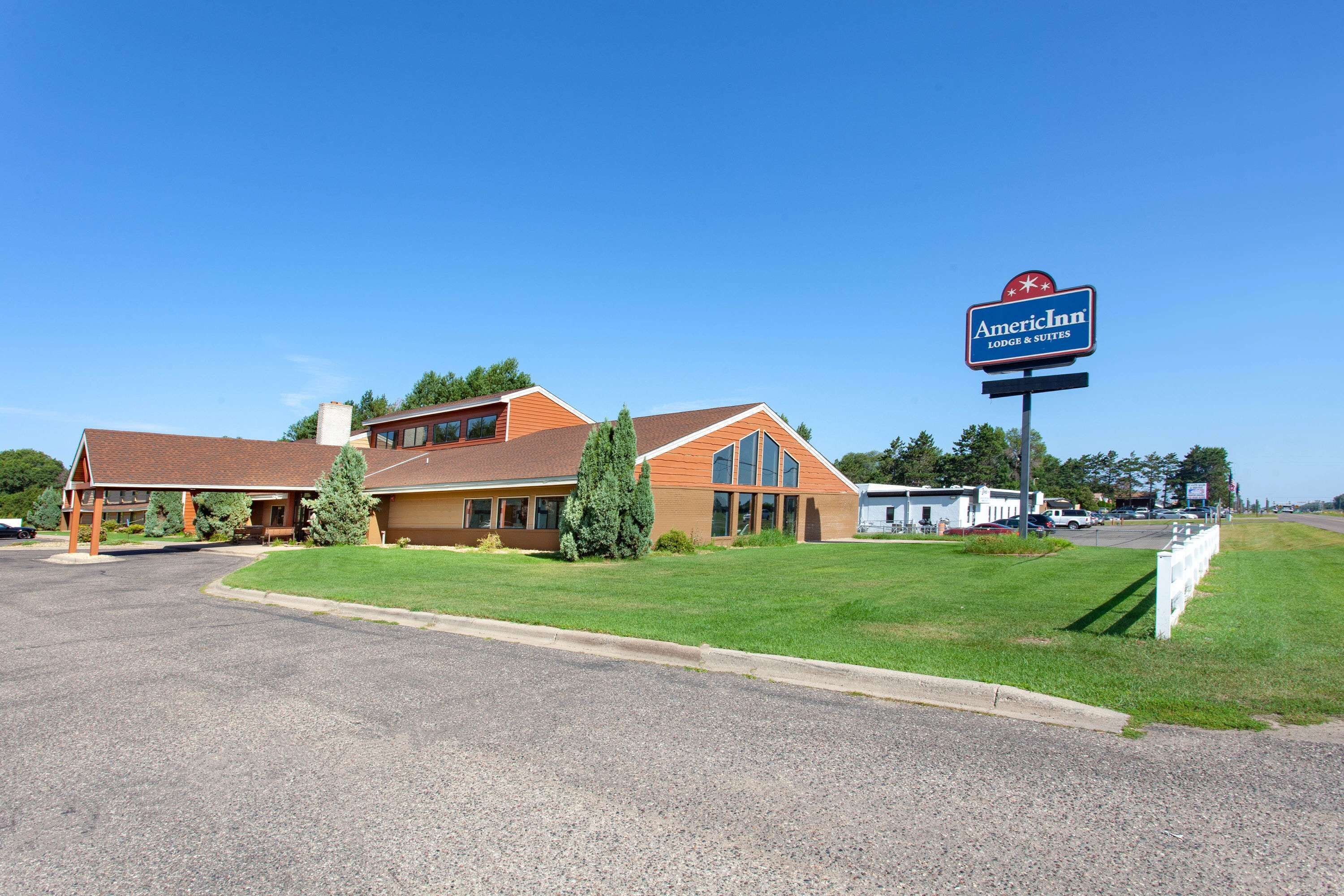 A two-story hotel with a large sign for AmeriInn Lodge & Suites.