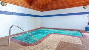 Une piscine dotée d’un plafond en bois et de murs carrelés.
