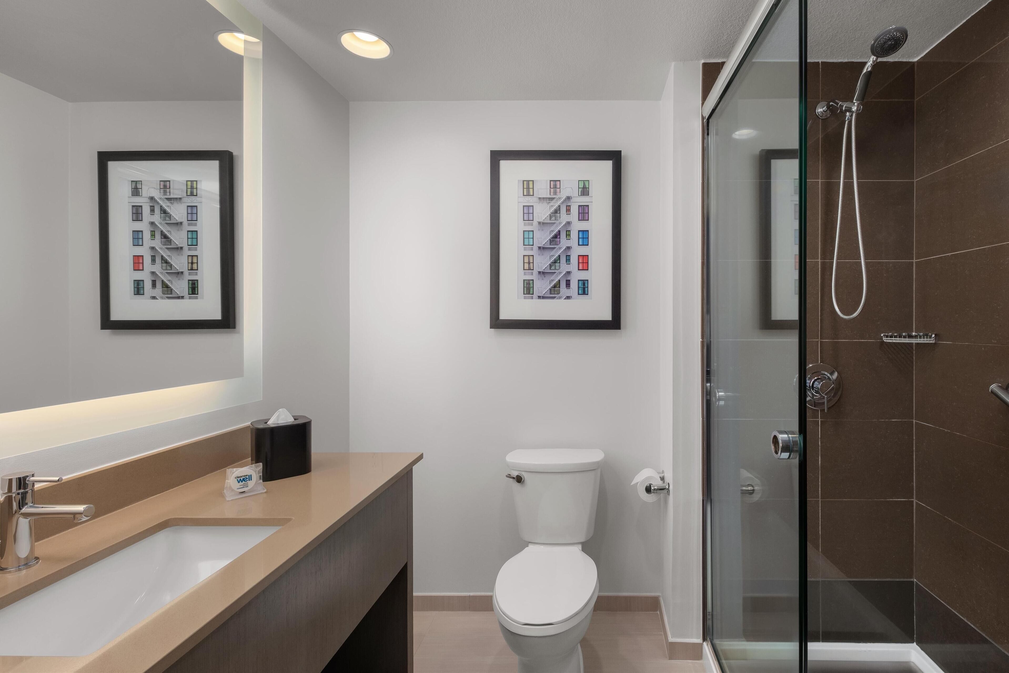 designer toiletries, hair dryer, towels