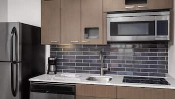 A modern kitchen with stainless steel appliances, a microwave, and a dishwasher.
