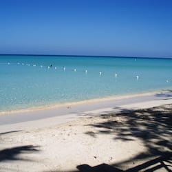 On the beach, white sand, sun loungers, beach umbrellas