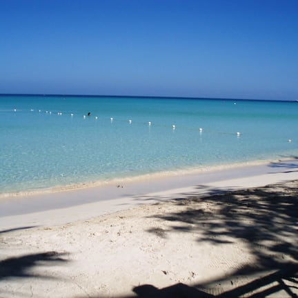 On the beach, white sand, sun loungers, beach umbrellas