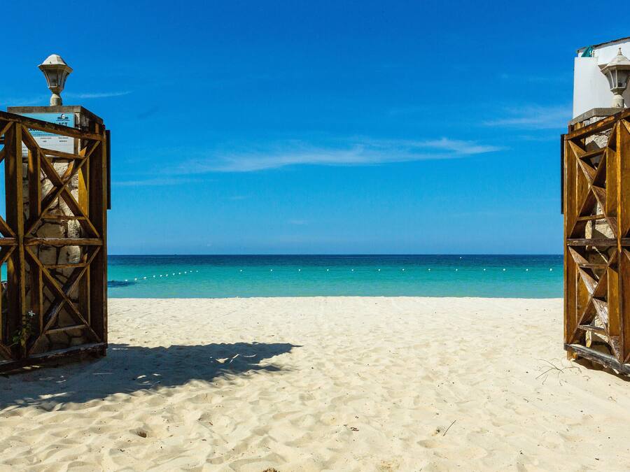 On the beach, white sand, sun loungers, beach umbrellas